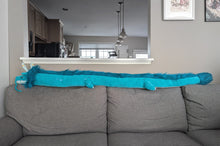 Load image into Gallery viewer, Gray sofa with a blue decorative dragon plush in front of a kitchen window.
